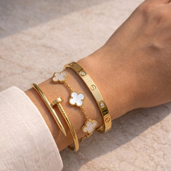 Model wearing aesthetic 3 piece anti tarnish gold plated bracelet stack.