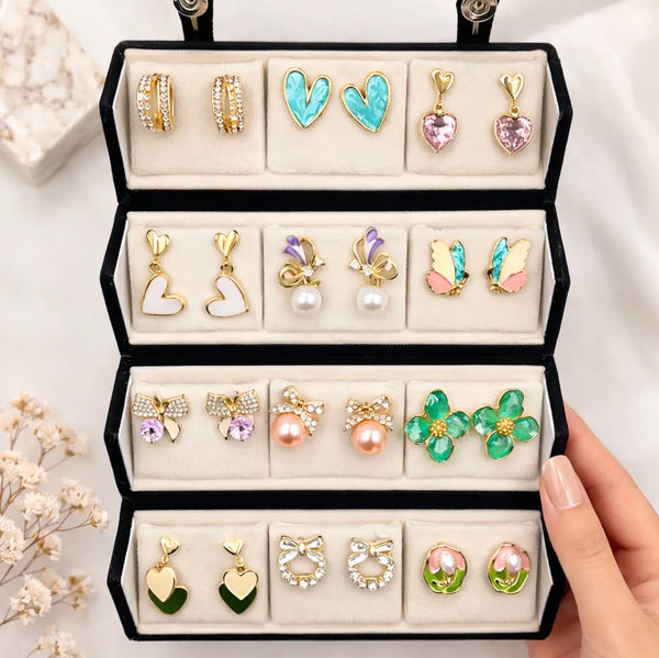 Open jewelry box displaying various pairs of earrings.