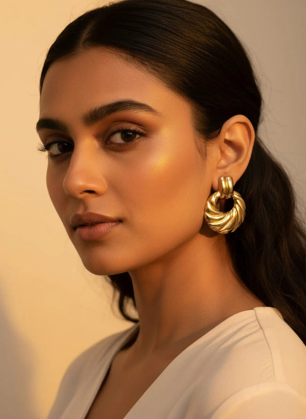 Front view of model wearing anti tarnish gold plated chunky croissant hoop earrings
