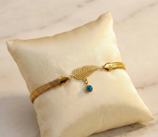 Anti-Tarnish Gold Plated Snake Chain Bracelet with Leaf and Evil Eye Charm on Marble Background