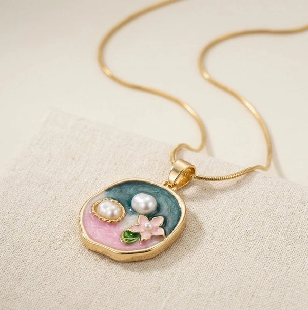 Anti-tarnish floral enamel necklace with pearls on a cream background