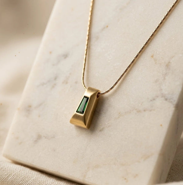 Close up of anti tarnish gold plated necklace with green rectangular pendant