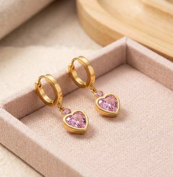 Close up details of pink heart drop earrings showing anti tarnish finish