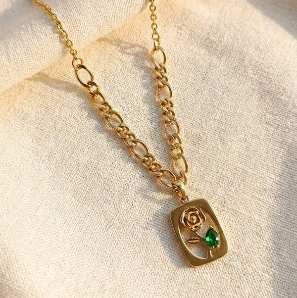 Front view of vintage rose pendant gold plated necklace with green stone