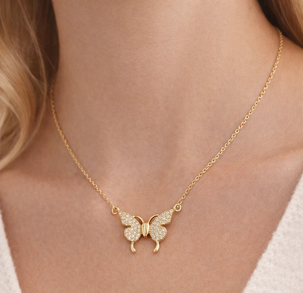 Woman wearing gold plated butterfly pendant necklace