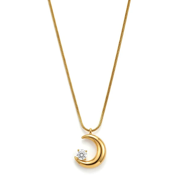Gold necklace with a crescent moon pendant on a white background
