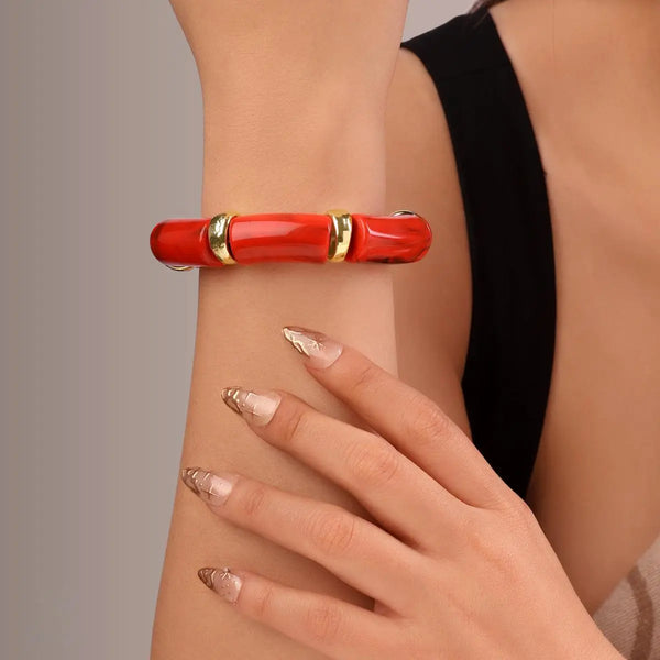 Crimson red tube statement bracelet with gold accents front view