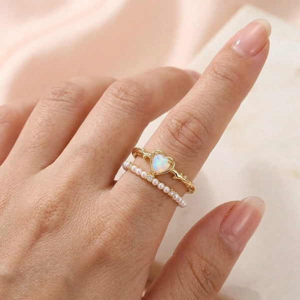 Front view of dainty heart opal and pearl stacking ring set in anti tarnish gold plating