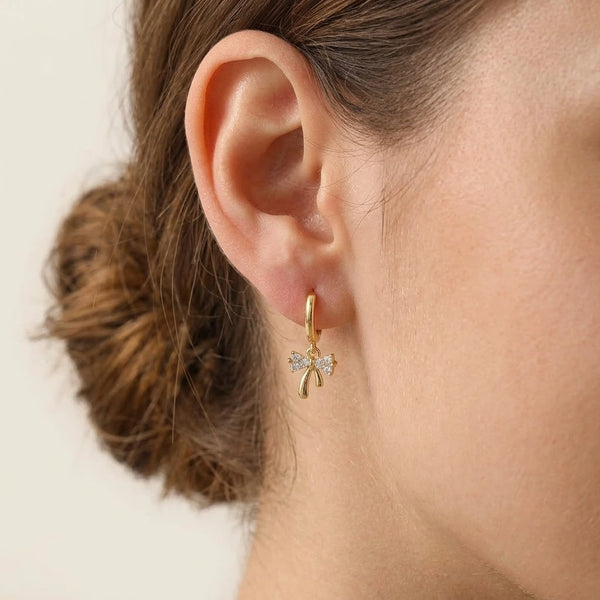 Woman wearing dainty Korean minimalist style bow hoop earrings