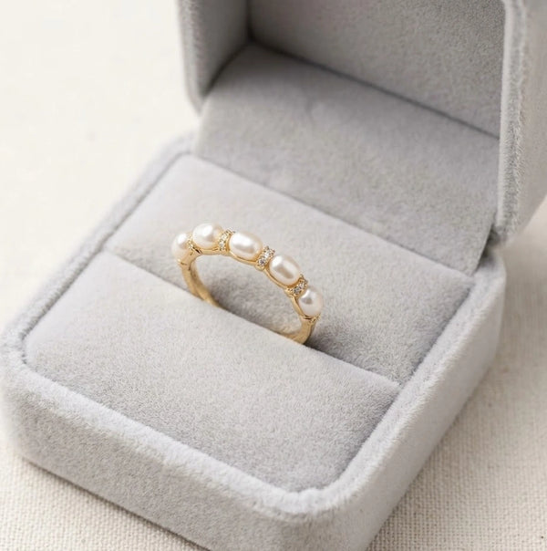 Side angle of dainty minimalist 3 pearl ring showing detailing and sparkling accents