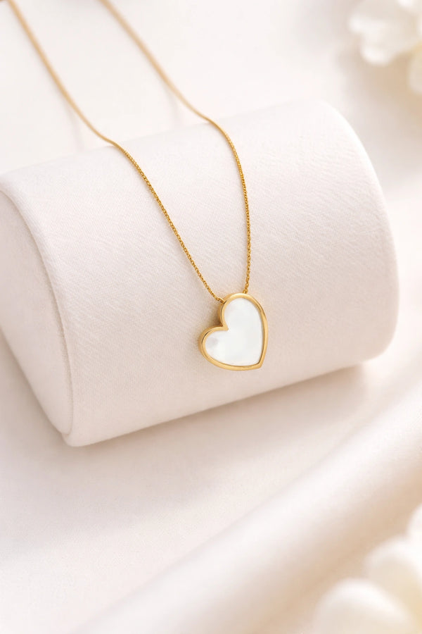 Woman wearing dainty white heart gold plated necklace