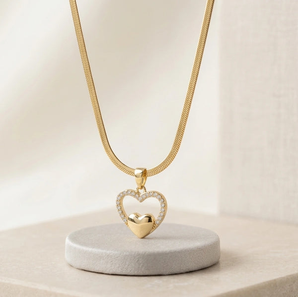 Woman wearing elegant double heart necklace on sleek snake chain