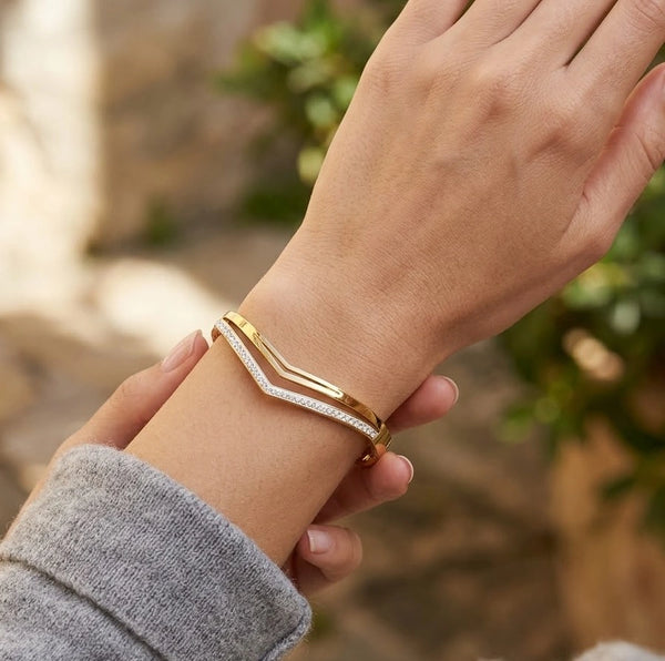Front view of double layer chevron v-shape gold-plated bracelet on woman's wrist