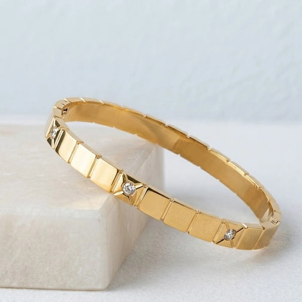 Elegant anti tarnish fashion jewelry bracelet resting on a light aesthetic background