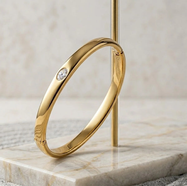 Elegant styling of the gold-tone single stone minimalist bracelet worn with casual outfit