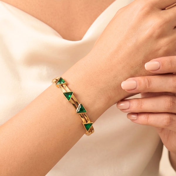Emerald green triangle anti-tarnish gold plated bracelet on wrist