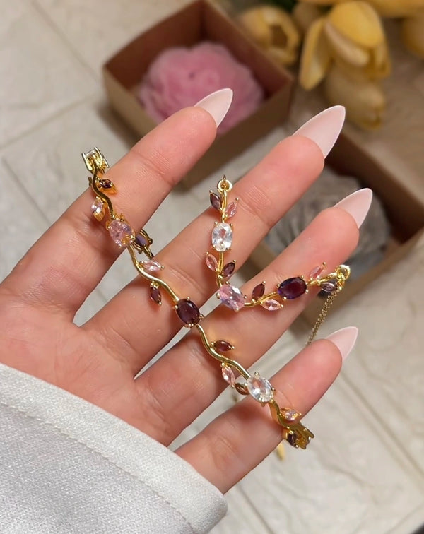 Front view of anti-tarnish floral vine necklace and bracelet set with pink and purple stones