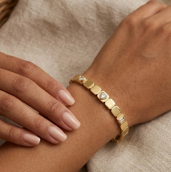 Woman wearing geometric square link anti-tarnish gold-plated bracelet with CZ stones