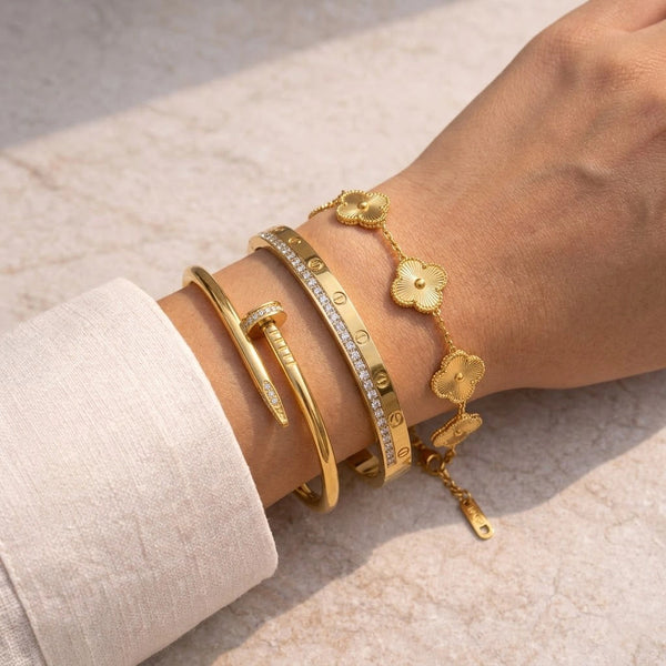 Gold textured clover motif chain bracelet with clasp in a premium satin-lined gift presentation box, product view.