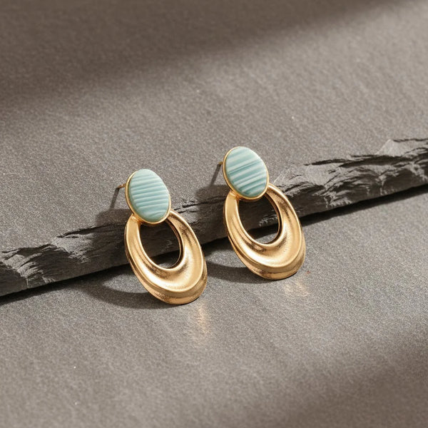 Gold plated oval drop earrings with turquoise stone and textured finish for women.