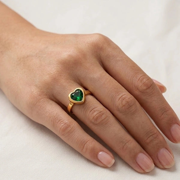 Hand wearing green heart stone anti-tarnish gold plated ring