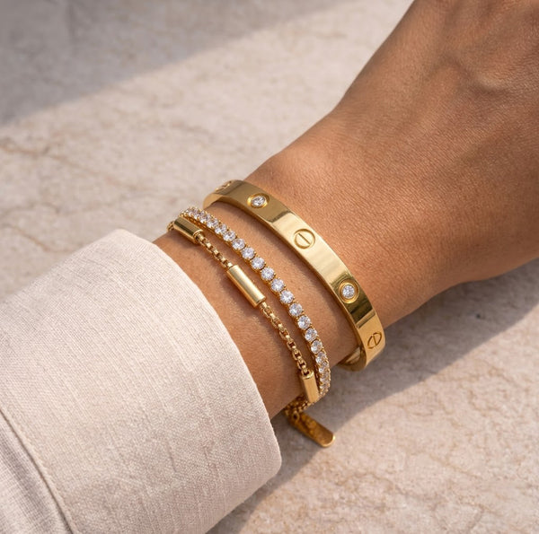 Close up of a model wearing the anti-tarnish 2-piece studded bangle and tennis bracelet stack.