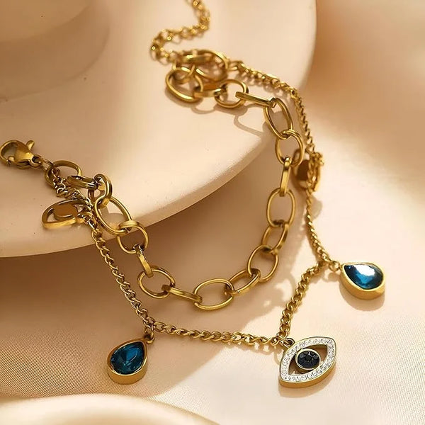 Aesthetic flat lay of trendy evil eye blue stone bracelet stainless steel material