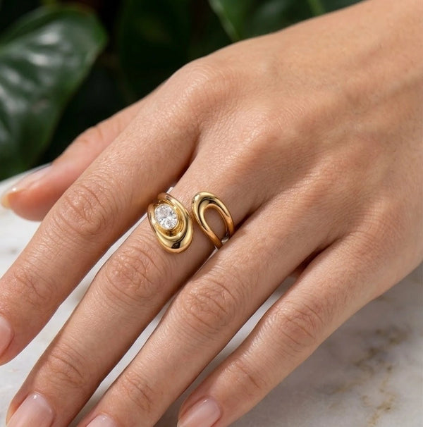 Minimalist crescent moon gold plated ring being worn on a finger showing the adjustable fit
