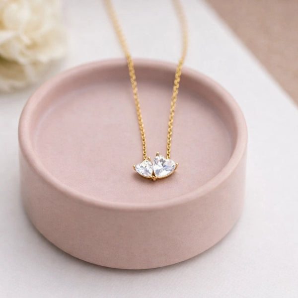 Woman wearing the minimalist anti-tarnish gold plated double heart chain necklace