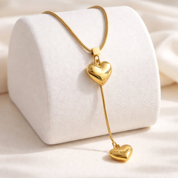 Woman wearing the minimalist double heart tassel pendant necklace