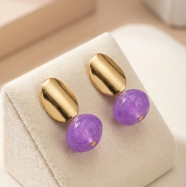 Side view of minimalist pastel purple and gold drop earrings