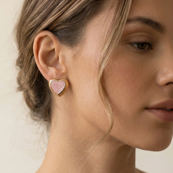 Front view of pink enamel heart stud fashion earrings with gold border