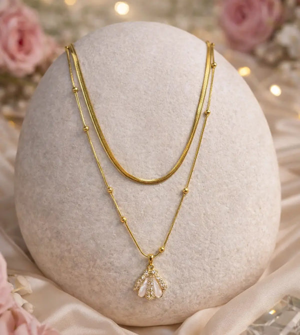 Pink enamel shell pendant with zircon detail close up gold plated charm necklace