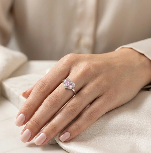Pink heart shape halo fashion ring for women on light background