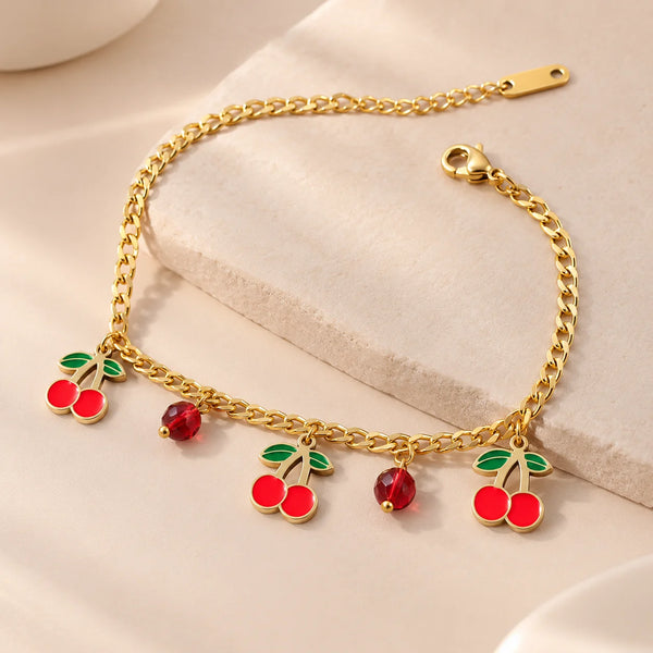 Front view of red cherry charm bracelet in anti tarnish gold plated finish