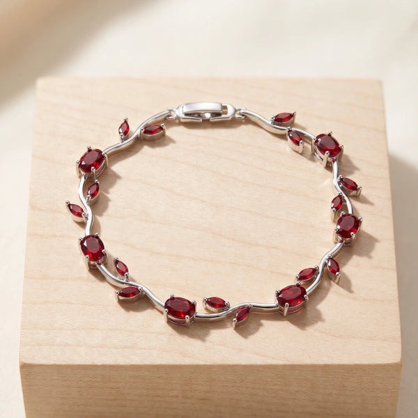 Front view of elegant red stone floral vine bracelet