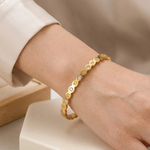 Front view of elegant roman numeral anti tarnish gold plated bracelet with stones