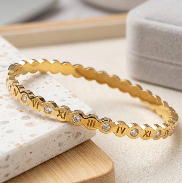 Side angle view showing the roman numeral cutouts on gold plated bracelet
