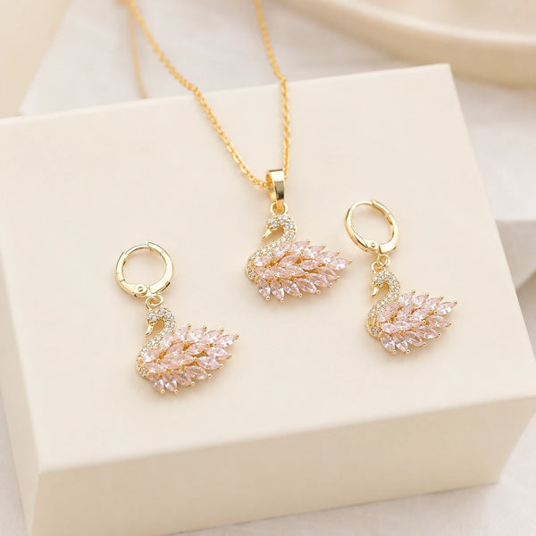 Close up of pink crystal swan pendant gold plated jewelry combo