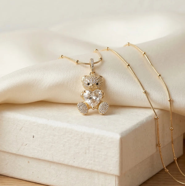 Close up detail of crystal heart and pave stones on teddy bear pendant