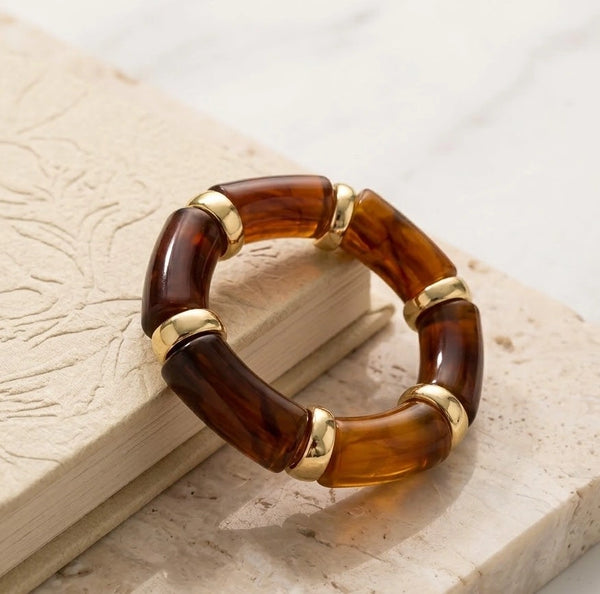 Close up of tortoise shell resin bracelet on wrist