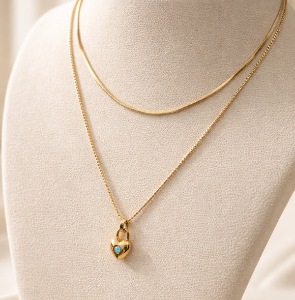 Close up detail of heart padlock pendant and anti tarnish chains