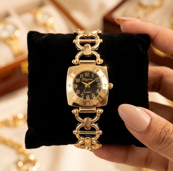 Chain link strap detail of the elegant anti-tarnish gold plated watch resting on a green cushion.