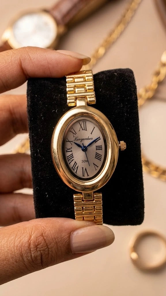 Vintage oval gold plated watch with Roman numerals on a black cushion display
