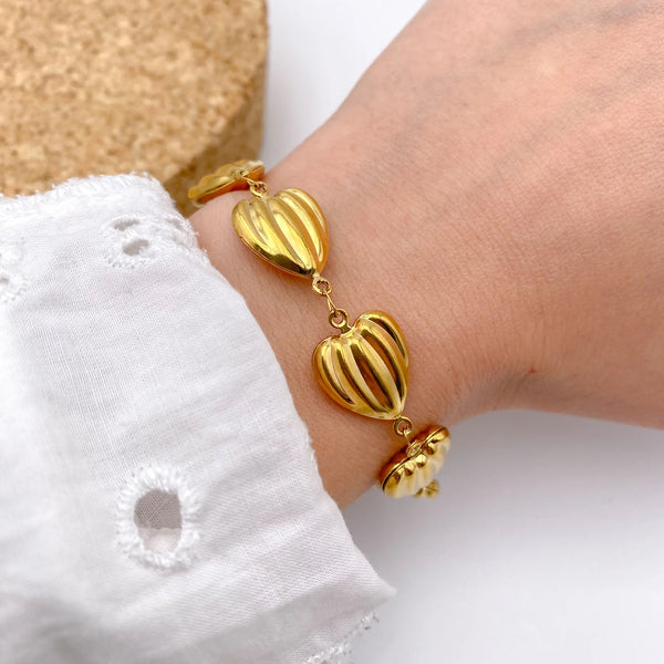 Top view of waterproof stainless steel gold plated charm bracelet