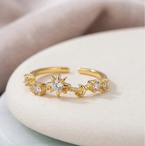 Woman's hand wearing anti-tarnish gold-plated star and moon ring