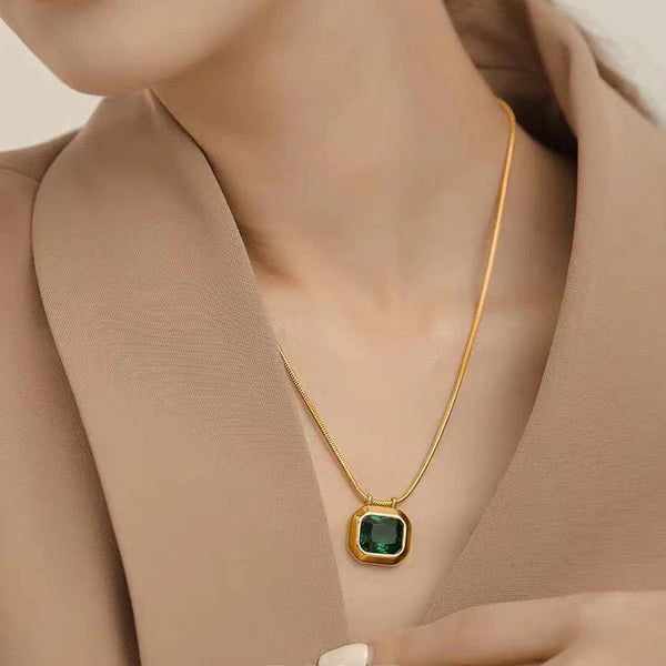 Woman wearing minimal emerald green pendant necklace daily wear