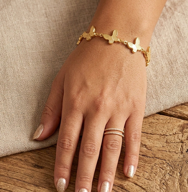 Stylish gold plated butterfly bracelet being worn as everyday fashion jewelry
